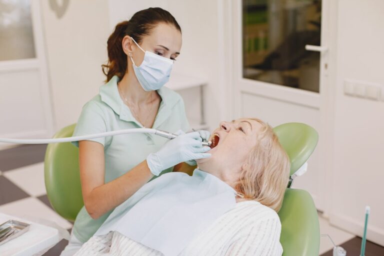 A Dentist Checking on Patient's Teeth