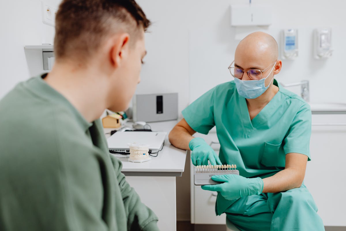 A Dentist Holding a Dental Shade Guide