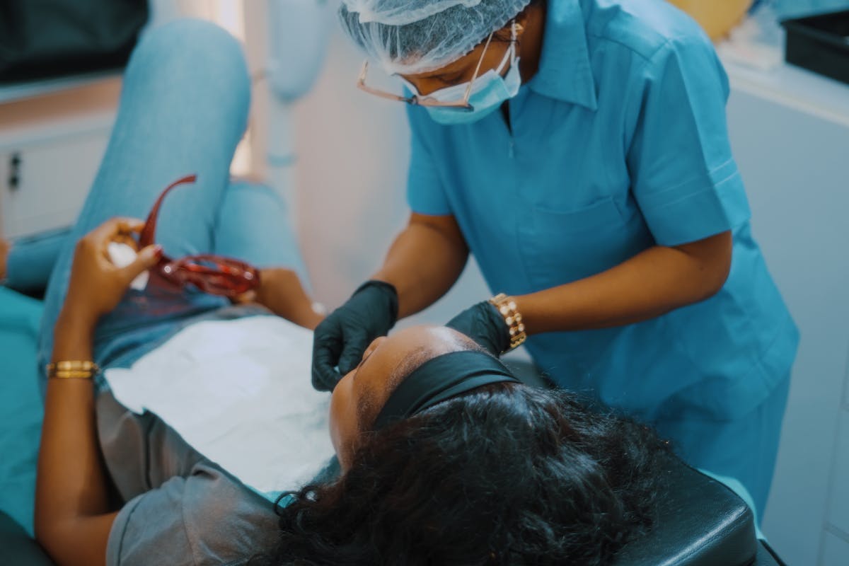 A woman getting her teeth checked by a dentist