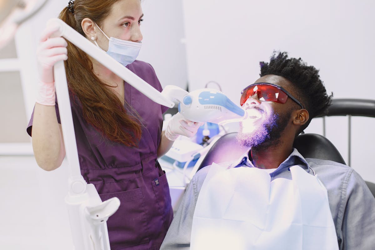 Dentist Whitening Mans Teeth