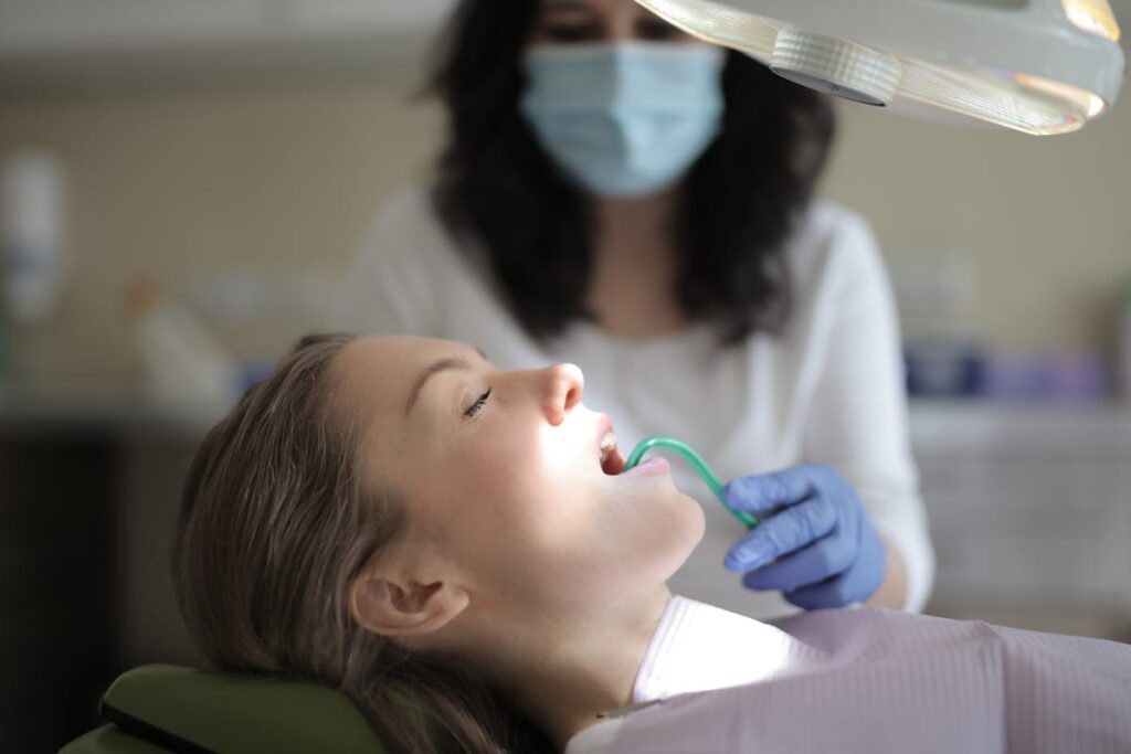 Female patient healing teeth during medical procedure in modern clinic