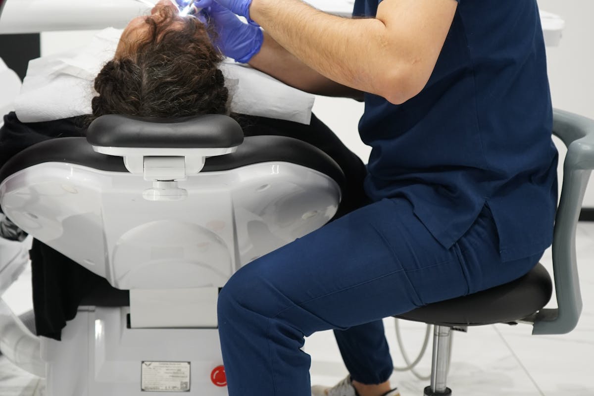 Male Dentist Treating a Patient