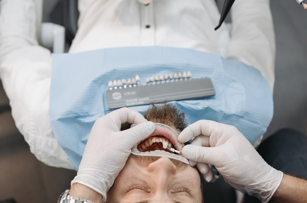 Dentist Hands over Patient Lying Down