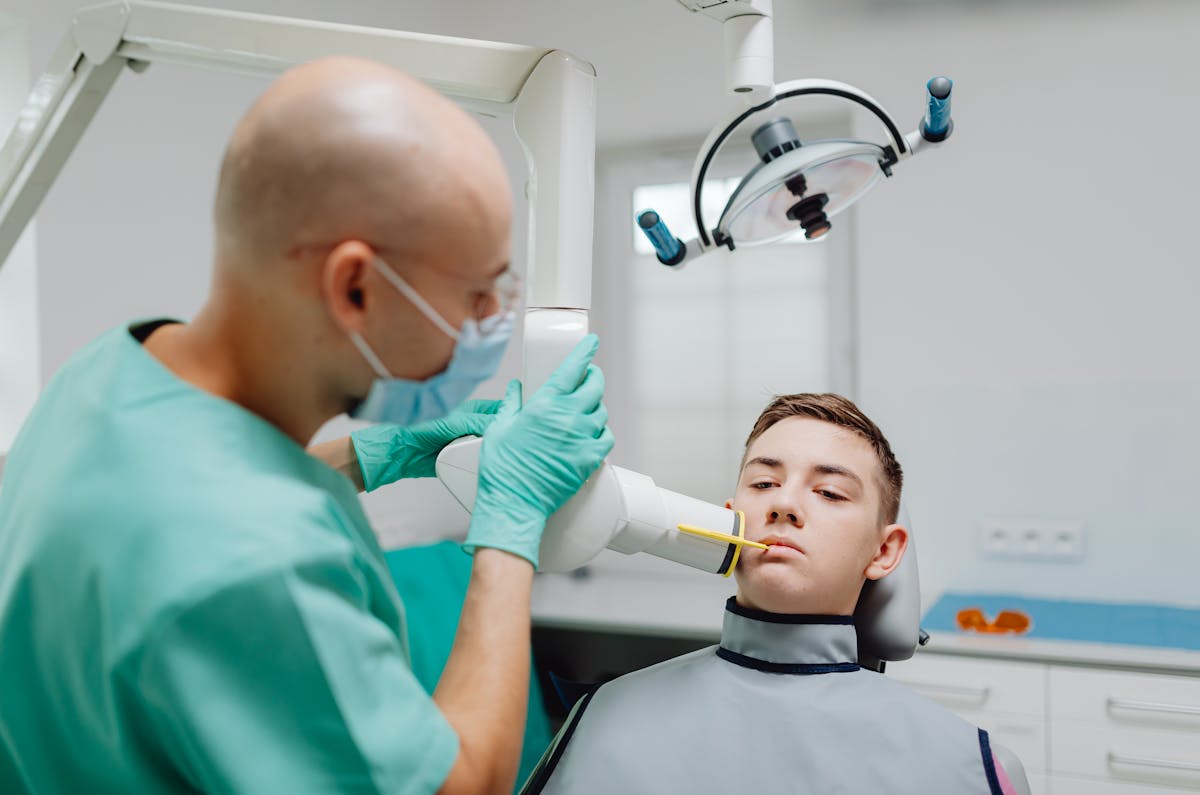 A Medical Professional Using a Dental Equipment on a Patient