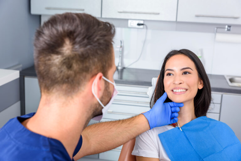 A young Dentist treating a female Patient in a dental practice.